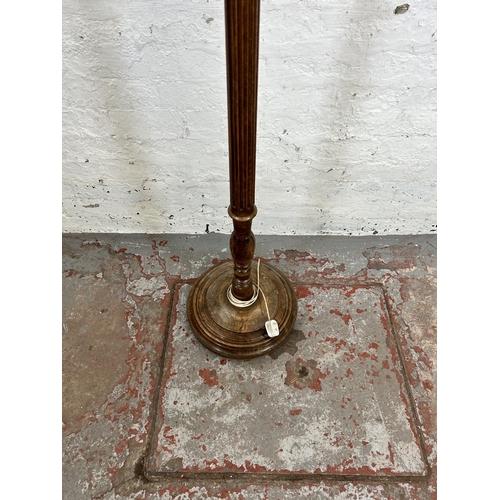 31 - A mid 20th century beech standard lamp with reeded column and circular base - approx. 180cm high