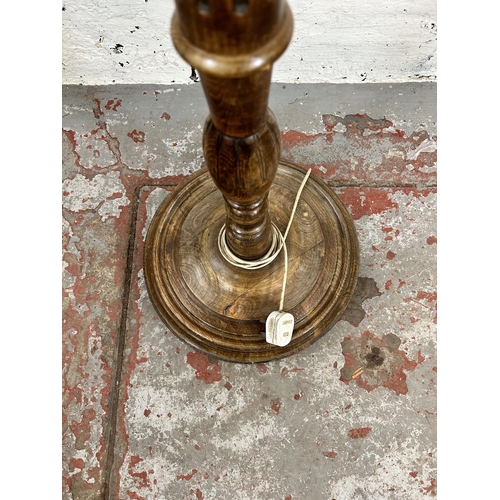 31 - A mid 20th century beech standard lamp with reeded column and circular base - approx. 180cm high