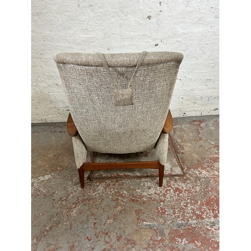 32 - A 1960s teak and fabric upholstered rocking armchair, stamped Norsk Pat. NR. 96981 - approx. 100cm h... 