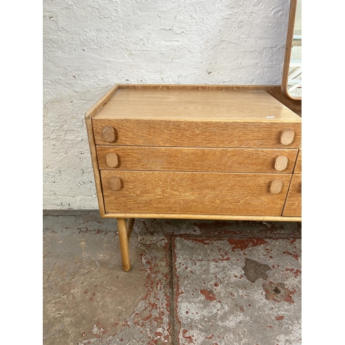 35 - A mid 20th century Meredew oak dressing table with five drawers and upper mirror