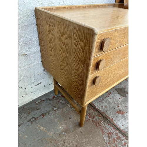 35 - A mid 20th century Meredew oak dressing table with five drawers and upper mirror