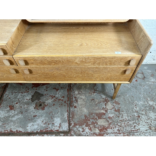 35 - A mid 20th century Meredew oak dressing table with five drawers and upper mirror