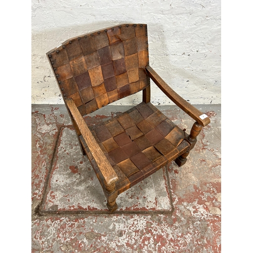 37 - A Cromwellian style leather and oak low seated armchair