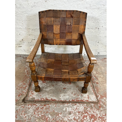 37 - A Cromwellian style leather and oak low seated armchair