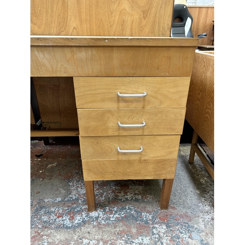 38 - A mid 20th century plywood office desk with three drawers