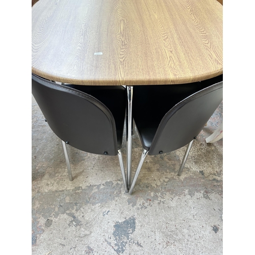 5 - A modern oak effect and tubular metal dining table and four brown leatherette space saving dining ch... 