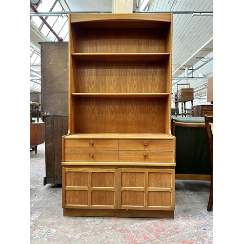 64 - A Nathan teak bookcase with four drawers and two lower cupboard doors - approx. 194cm high x 102cm w... 