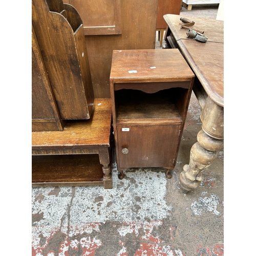 66 - Five pieces of oak furniture to include Art Deco bookcase with external newspaper rack, bedside cabi... 