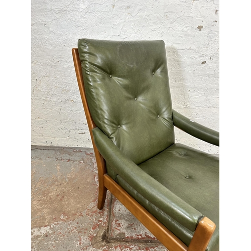 82 - A mid 20th century beech and green vinyl armchair