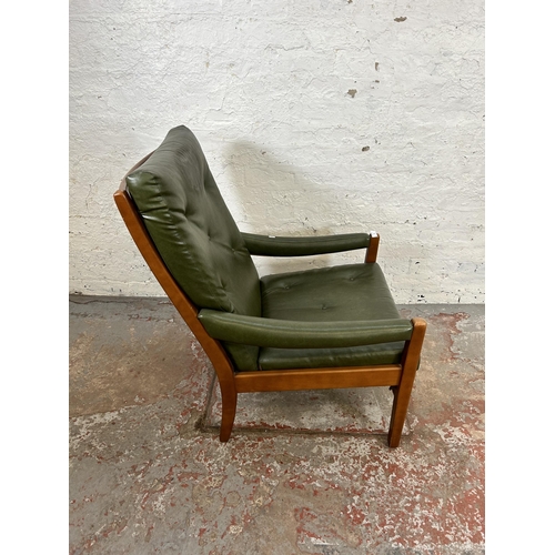 82 - A mid 20th century beech and green vinyl armchair