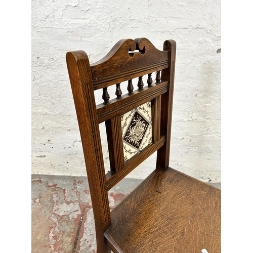 97 - A 19th century oak hall chair with ceramic tile insert