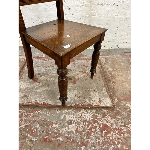 97 - A 19th century oak hall chair with ceramic tile insert