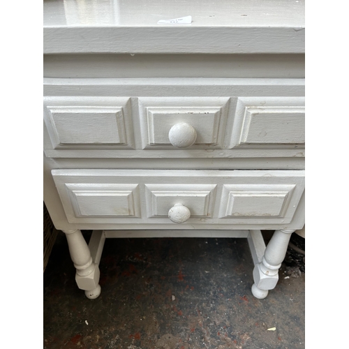 147 - A modern white painted two drawer bedside table