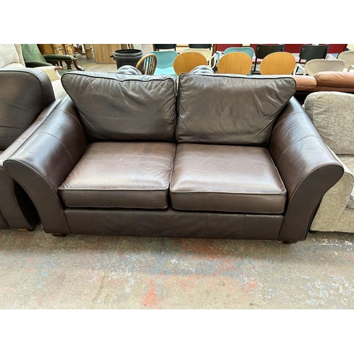 163A - A Marks & Spencer brown leather two piece lounge suite comprising three seater sofa and reclining ar... 