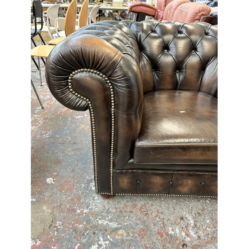 165 - A brown leather Chesterfield club armchair