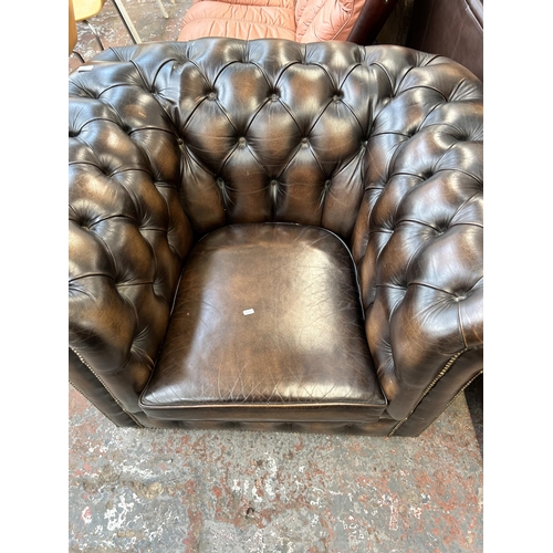 165 - A brown leather Chesterfield club armchair