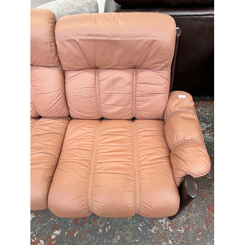 166 - A vintage Ekornes Montana dark teak and pink leather two seater sofa