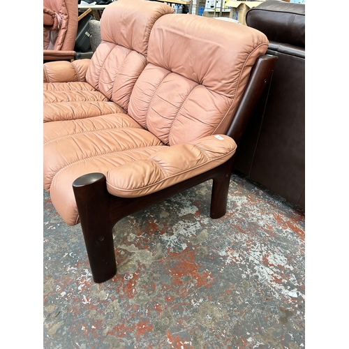 166 - A vintage Ekornes Montana dark teak and pink leather two seater sofa