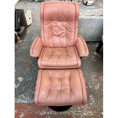 167 - A Ekornes Stressless pink leather swivel recliner armchair with footstool