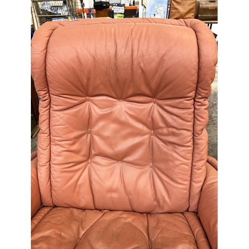 167 - A Ekornes Stressless pink leather swivel recliner armchair with footstool