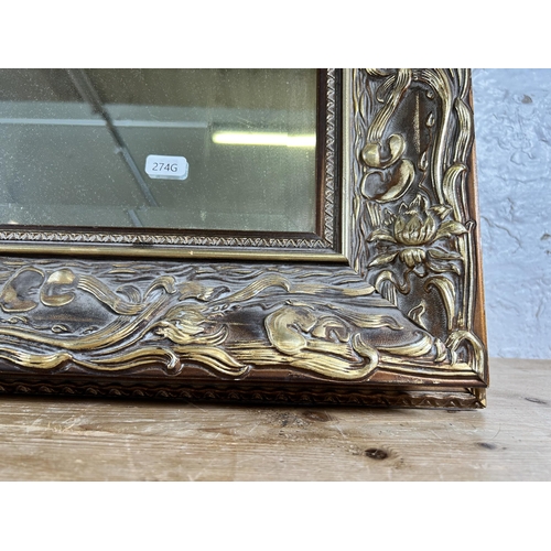 181 - An Art Nouveau style gilt framed bevelled edge wall mirror - approx. 79cm high x 108cm wide