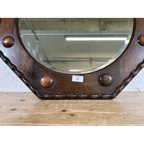 197 - An early 20th century oak framed octagonal wall mirror - approx. 61cm square