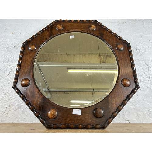 197 - An early 20th century oak framed octagonal wall mirror - approx. 61cm square