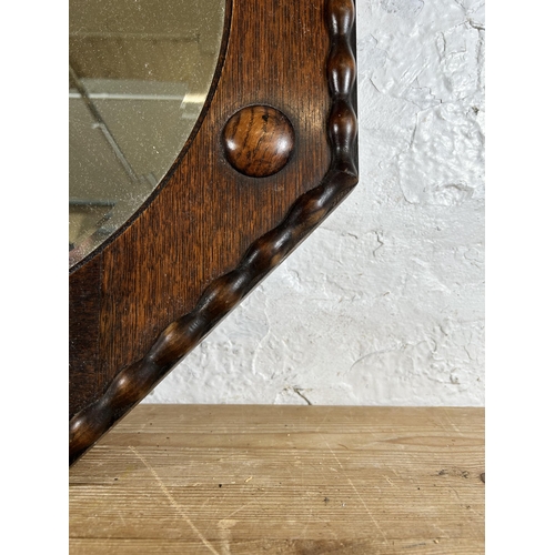 197 - An early 20th century oak framed octagonal wall mirror - approx. 61cm square