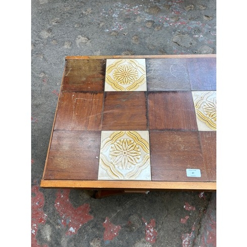 27 - A mid 20th century beech rectangular coffee table with ceramic and teak tile inserts