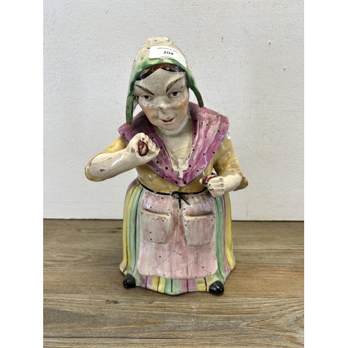 204 - A 19th century Staffordshire pottery jar in the form of a woman - approx. 30cm high