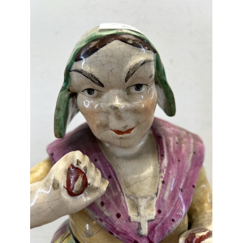 204 - A 19th century Staffordshire pottery jar in the form of a woman - approx. 30cm high