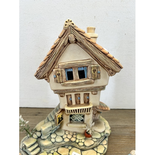 205 - Four Pendelfin items, three figurines and one Castle Tavern display stand