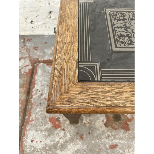 141 - An Arts and Crafts oak square side table with later added ceramic tile insert