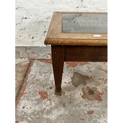 141 - An Arts and Crafts oak square side table with later added ceramic tile insert