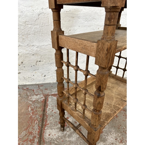 142 - An Arts and Crafts oak reading bookcase by Leonard Wyburd for Liberty & Co.