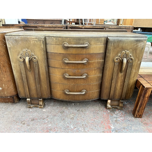 143 - An Art Deco style oak sideboard with four central drawers and two outer cupboard doors