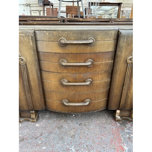 143 - An Art Deco style oak sideboard with four central drawers and two outer cupboard doors