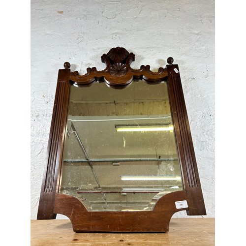 180 - An Edwardian carved mahogany framed wall mirror - approx.  78cm x 55cm wide