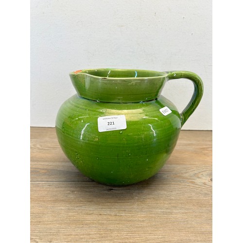 221 - A late 19th/early 20th century C. H. Brannam Devon green glazed terracotta jug - approx. 20cm high