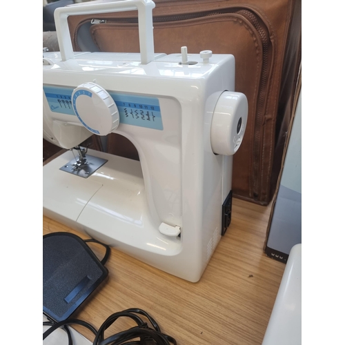 771 - A cased Aisin Seiki Co Ltd Classic electric sewing machine with foot pedal and instruction manual