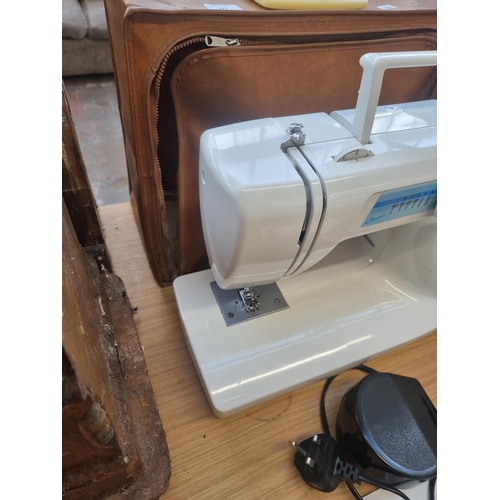 771 - A cased Aisin Seiki Co Ltd Classic electric sewing machine with foot pedal and instruction manual