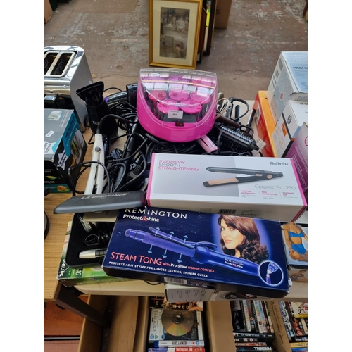 783 - A large collection of beauty and grooming items to include hair curlers, hair straighteners, hair dr... 