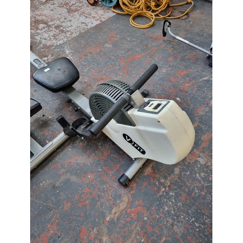 815 - A collection of exercise equipment to include V-Fit rowing machine, black metal barbell, Reebok cros... 