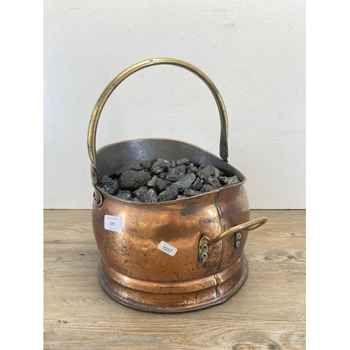 277 - A Victorian style copper helmet coal scuttle with coal