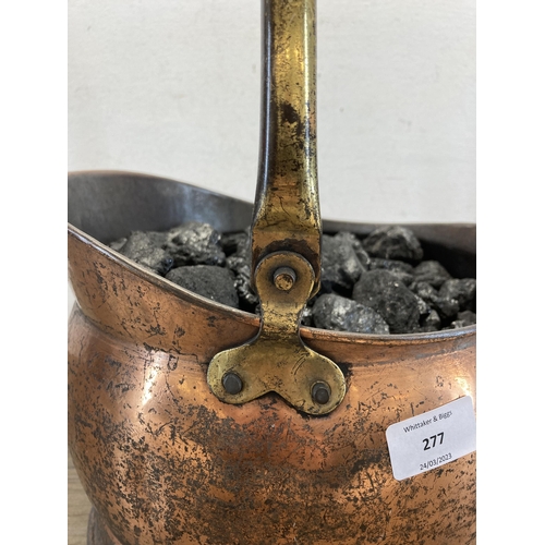 277 - A Victorian style copper helmet coal scuttle with coal