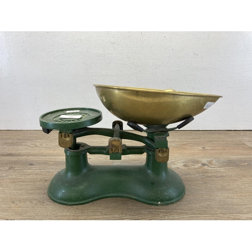 281 - A set of early 20th century Victor England green painted cast iron weighing scales with brass weight... 