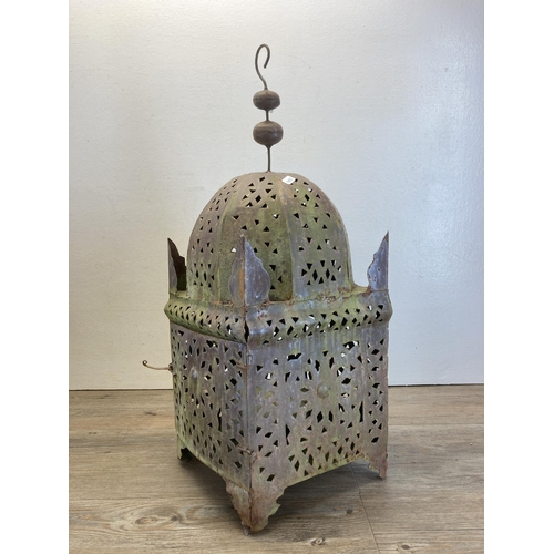 291 - A pair of Middle Eastern style pierced cast metal hanging lanterns - approx. 62cm high