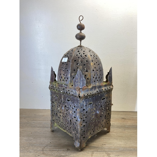 291 - A pair of Middle Eastern style pierced cast metal hanging lanterns - approx. 62cm high