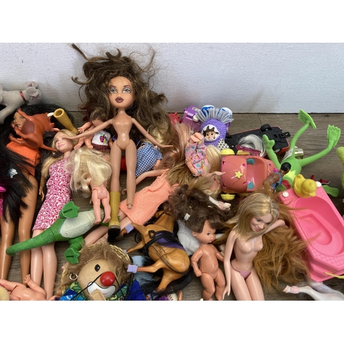 327 - A collection of soft toys and plastic dolls