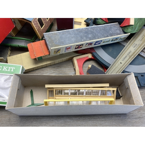 343 - A large collection of Hornby and Peco model railway buildings and accessories